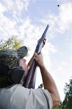 shooting weapon - Man hunting with rifle Stock Photo - Premium Royalty-Free, Code: 6102-08748699