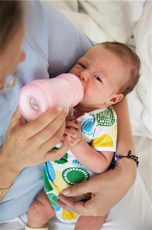 Mother feeding baby girl, high angle view Stock Photo - Premium Royalty-Free, Code: 6102-08760132