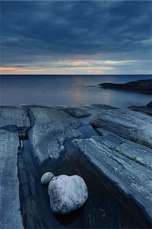 dark cloud over water - Vanern lake rocky shore at evening Stock Photo - Premium Royalty-Free, Code: 6102-08760207