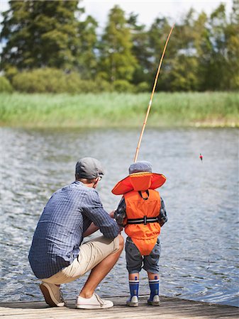 simsearch:6102-08746775,k - Father with son fishing on jetty Foto de stock - Sin royalties Premium, Código: 6102-08760493