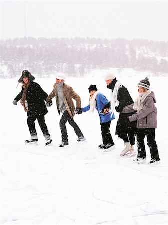 Five people skating holding hands. Stock Photo - Premium Royalty-Free, Code: 6102-08760499