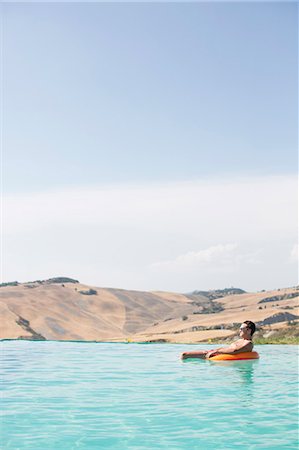 Mid adult man relaxing in swimming pool Stock Photo - Premium Royalty-Free, Code: 6102-08760421