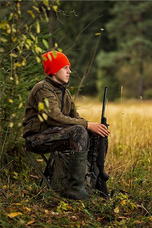 Teenage boy with rifle at hunting Stock Photo - Premium Royalty-Free, Code: 6102-08760437