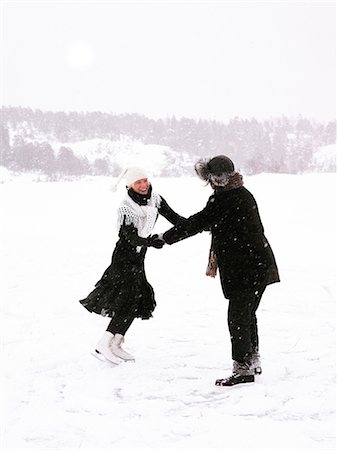 A man and a woman skating holding hands. Stock Photo - Premium Royalty-Free, Code: 6102-08760503