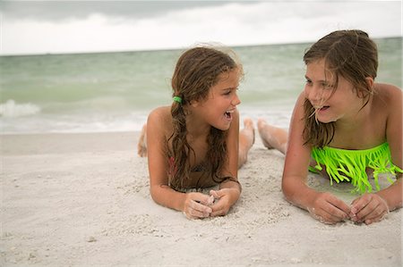 simsearch:6102-03749947,k - Two girl lying on beach Stock Photo - Premium Royalty-Free, Code: 6102-08760638