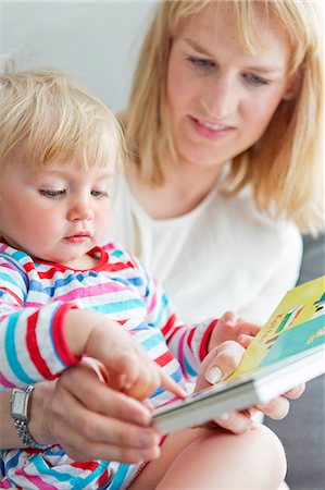 simsearch:6102-08000909,k - Mother with daughter reading book Photographie de stock - Premium Libres de Droits, Code: 6102-08760829