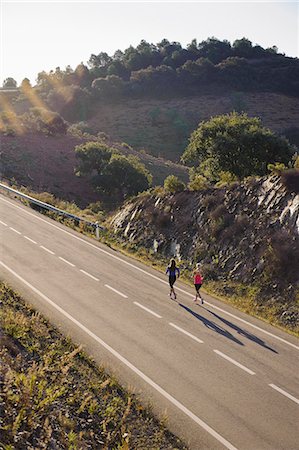 simsearch:400-07093421,k - Runners running on road, high angle view Stock Photo - Premium Royalty-Free, Code: 6102-08760954