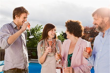 Happy people drinking champagne together Stock Photo - Premium Royalty-Free, Code: 6102-08760901
