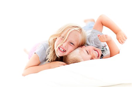 Happy brother and sister, studio shot Stock Photo - Premium Royalty-Free, Code: 6102-08760911