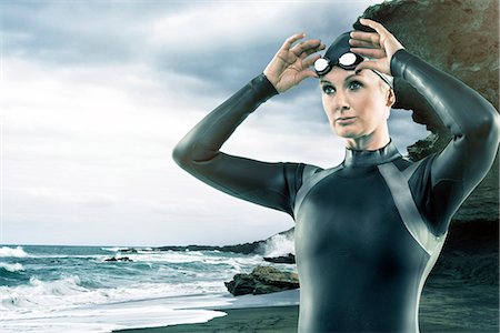 MI adult woman in wetsuit at beach Stock Photo - Premium Royalty-Free, Code: 6102-08760934