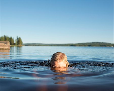 pre teens bath girls - Girl swimming in lake, Siljan, Dalarna, Sweden Stock Photo - Premium Royalty-Free, Code: 6102-08761318