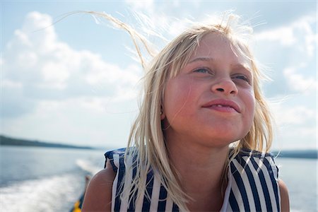 Smiling girl on boat, Siljan, Dalarna, Sweden Stock Photo - Premium Royalty-Free, Code: 6102-08761327