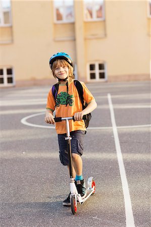 Boy with kick scooter on schoolyard, Stockholm, Sweden Stock Photo - Premium Royalty-Free, Code: 6102-08761442