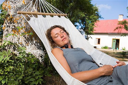 sleeping backyard - A woman resting in a hammock. Stock Photo - Premium Royalty-Free, Code: 6102-08761671