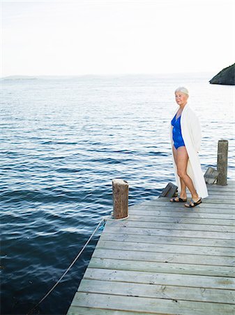 simsearch:6102-08566169,k - A senior woman with swimming clothes on a jetty. Stock Photo - Premium Royalty-Free, Code: 6102-08768699