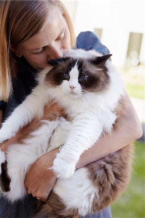 fat women petting - Woman holding cat Stock Photo - Premium Royalty-Free, Code: 6102-08858346