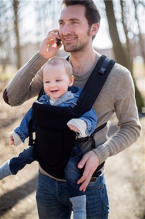 simsearch:6102-08858419,k - Man with baby boy in carrier Stock Photo - Premium Royalty-Free, Code: 6102-08858418