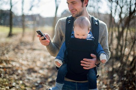 simsearch:6102-08858419,k - Man with baby boy in carrier Stock Photo - Premium Royalty-Free, Code: 6102-08858419
