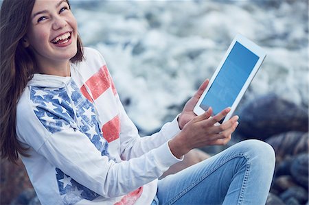 Girl with digital tablet on beach Stock Photo - Premium Royalty-Free, Code: 6102-08858517