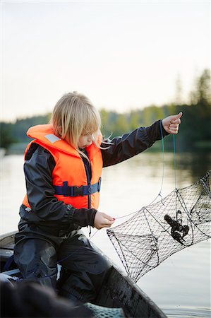 Girl with crayfish trap Stock Photo - Premium Royalty-Free, Code: 6102-08881789