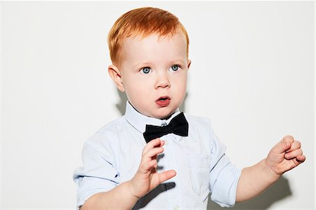 simsearch:6102-06336642,k - Portrait of toddler wearing bow tie Foto de stock - Sin royalties Premium, Código: 6102-08881731