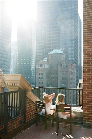 sitting on terrace - Girls looking at skyscrapers Stock Photo - Premium Royalty-Free, Code: 6102-08881732