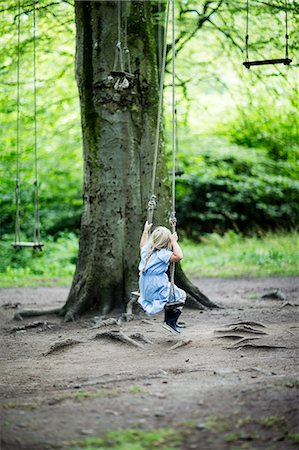 simsearch:6102-08952062,k - Small girl swinging in forest Stock Photo - Premium Royalty-Free, Code: 6102-08881851