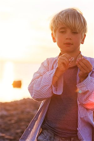 simsearch:6102-08559111,k - Blond boy on beach at sunset Stock Photo - Premium Royalty-Free, Code: 6102-08881913