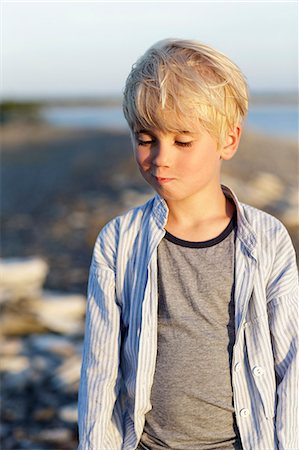 portrait in water reflection - Portrait of blond boy on sea coast Stock Photo - Premium Royalty-Free, Code: 6102-08881912