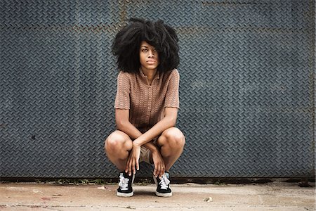 Young woman with afro hair Stock Photo - Premium Royalty-Free, Code: 6102-08885357