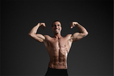 simsearch:6102-08995506,k - Man showing muscles Stock Photo - Premium Royalty-Free, Code: 6102-08885401