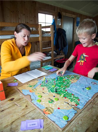 simsearch:6102-08995585,k - Mother with son playing board game Photographie de stock - Premium Libres de Droits, Code: 6102-08885594