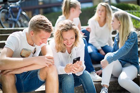 simsearch:6102-07843687,k - Friends sitting on steps together Stock Photo - Premium Royalty-Free, Code: 6102-08885717