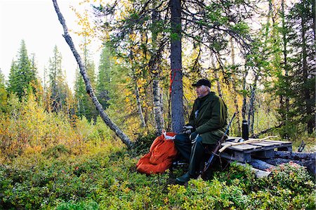 senior backpack - Hunter walking in forest Stock Photo - Premium Royalty-Free, Code: 6102-08800058