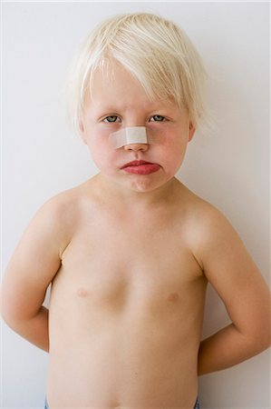 stomach pain - Girl with bandage on her face Stock Photo - Premium Royalty-Free, Code: 6102-08800096