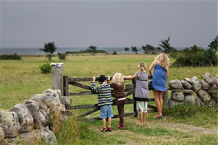 stone walls in meadows - Children standing next to wooden gate Stock Photo - Premium Royalty-Free, Code: 6102-08800135