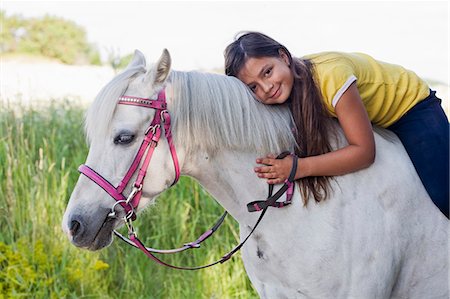 simsearch:6102-08746672,k - Portrait of girl sitting on horse Photographie de stock - Premium Libres de Droits, Code: 6102-08800219