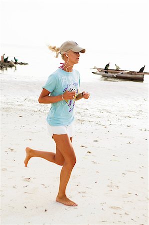 Woman jogging on beach Stock Photo - Premium Royalty-Free, Code: 6102-08800309