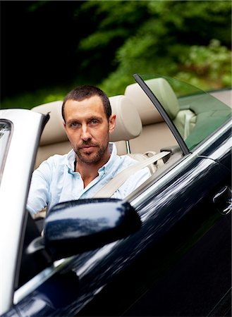 simsearch:6102-03905685,k - Portrait of man in convertible car Stock Photo - Premium Royalty-Free, Code: 6102-08800337