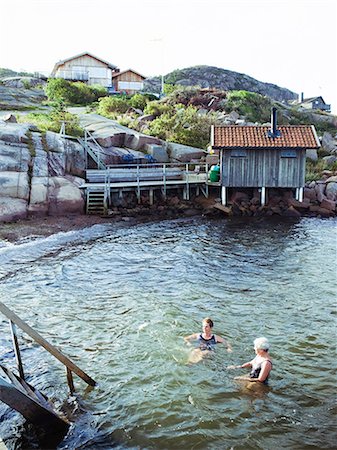 simsearch:6102-08761067,k - Two senior women swimming in the sea, Sweden. Fotografie stock - Premium Royalty-Free, Codice: 6102-08800564