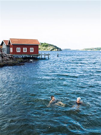senior woman exercising by ocean - Two senior women swimming in the sea, Sweden. Stock Photo - Premium Royalty-Free, Code: 6102-08800565