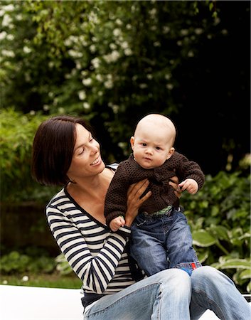 simsearch:6102-03827214,k - Portrait of a woman with holding her baby, Sweden. Photographie de stock - Premium Libres de Droits, Code: 6102-08800684