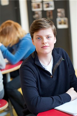 simsearch:6102-08951254,k - Portrait of smiling teenage boy in classroom Stock Photo - Premium Royalty-Free, Code: 6102-08951200
