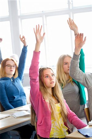 simsearch:6102-08951213,k - Teenage girls rising hands in classroom Foto de stock - Sin royalties Premium, Código: 6102-08951206