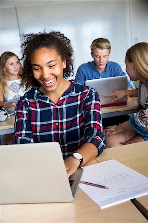 simsearch:6102-08951254,k - Teenagers with laptop in classroom Stock Photo - Premium Royalty-Free, Code: 6102-08951365