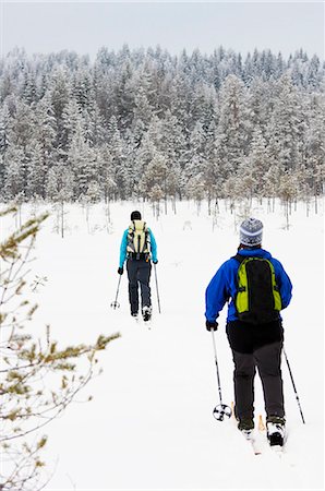 simsearch:6102-08520501,k - Women cross country skiing in winter forest Stock Photo - Premium Royalty-Free, Code: 6102-08951373