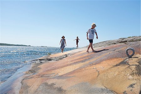 Mother walking with children by sea Stock Photo - Premium Royalty-Free, Code: 6102-08951309