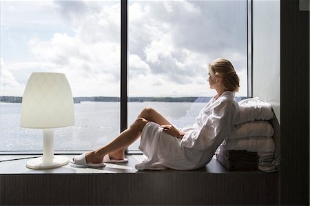 sea spa - Woman looking through window Stock Photo - Premium Royalty-Free, Code: 6102-08951504