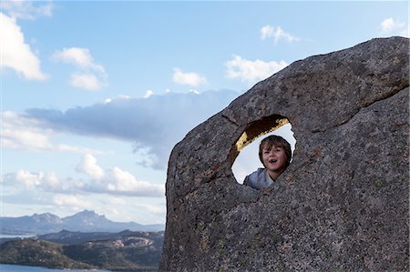 sardinia rural - Boy on rock looking at camera Stock Photo - Premium Royalty-Free, Code: 6102-08951788