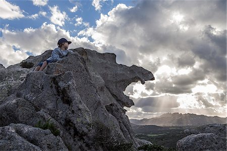 sardinia rural - Boy on rock looking at view Stock Photo - Premium Royalty-Free, Code: 6102-08951789